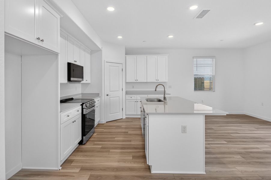A kitchen with white cabinets. A kitchen with white cabinets.