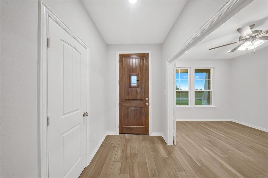Entrance foyer with light wood-type flooring and a ceiling fan Entrance foyer with light wood-type flooring and a ceiling fan