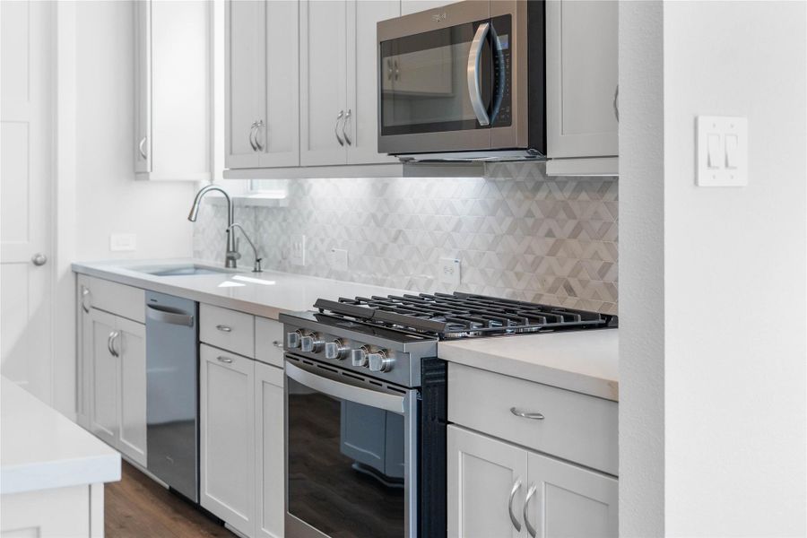 The stainless steel Whirlpool appliances integrated into this gorgeous kitchen.