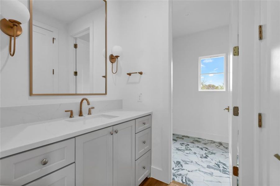 Bathroom with vanity and baseboards