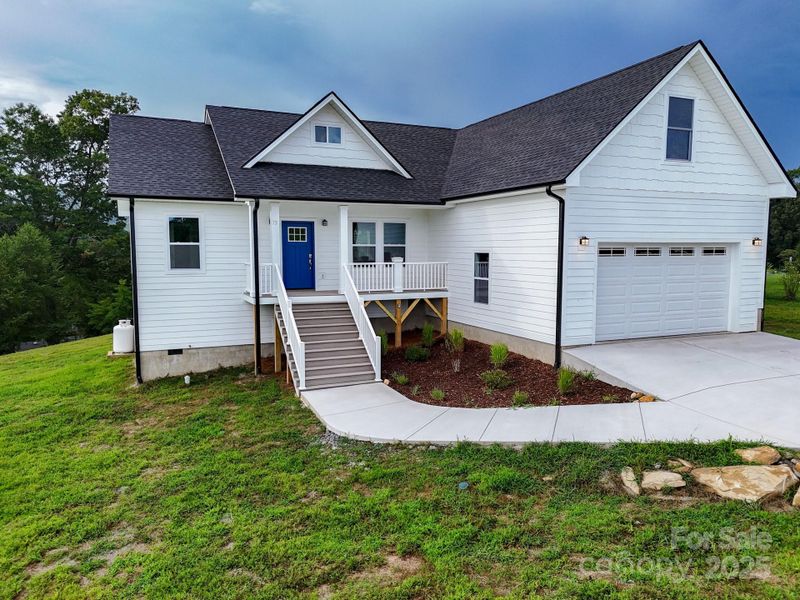 Front exterior of a new home in , Hendersonville, NC, highlighting curb appeal (Image 1). Front exterior of a new home in , Hendersonville, NC, highlighting curb appeal (Image 1).
