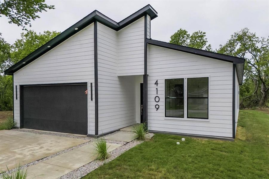 Modern architectural exterior with white horizontal siding and contrasting black trim Modern architectural exterior with white horizontal siding and contrasting black trim