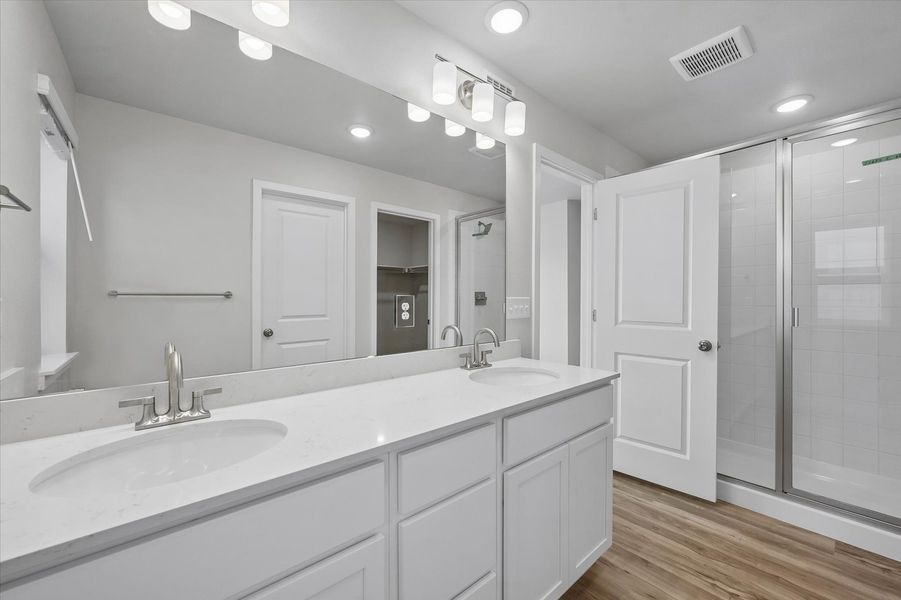 A bathroom with a large mirror.