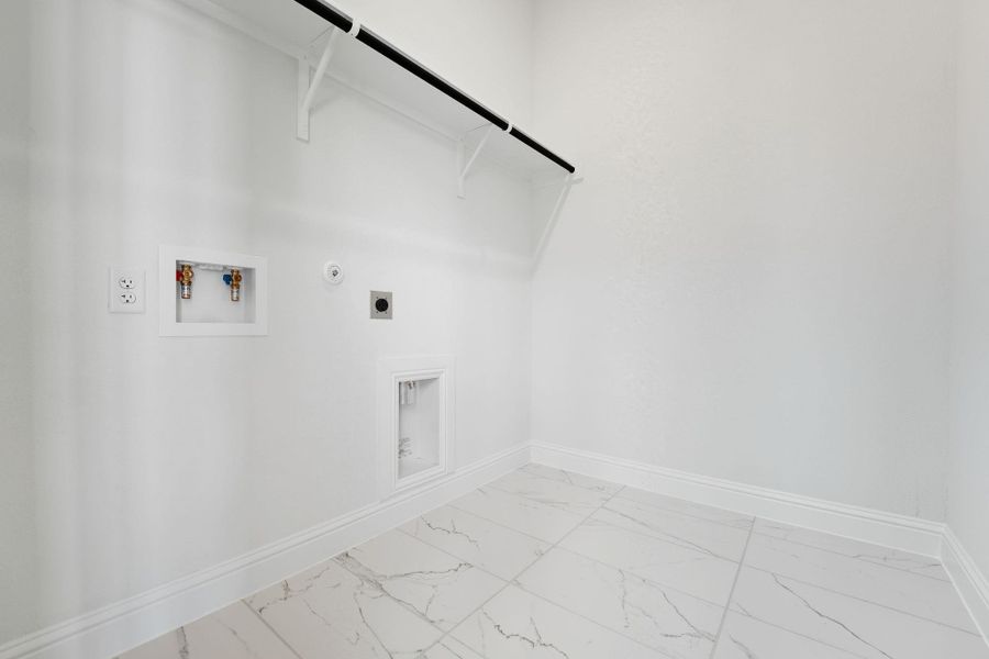 Laundry room with gas dryer hookup, light marble finish flooring, washer hookup, and electric dryer hookup