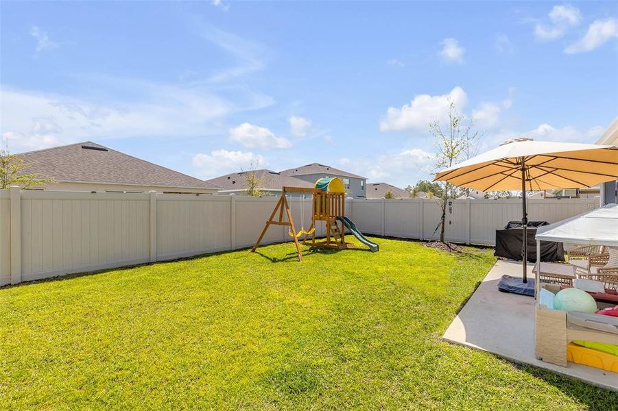 Exterior details and patio area of a home in Groveside at Ormond Station, Ormond Beach (Image 25).