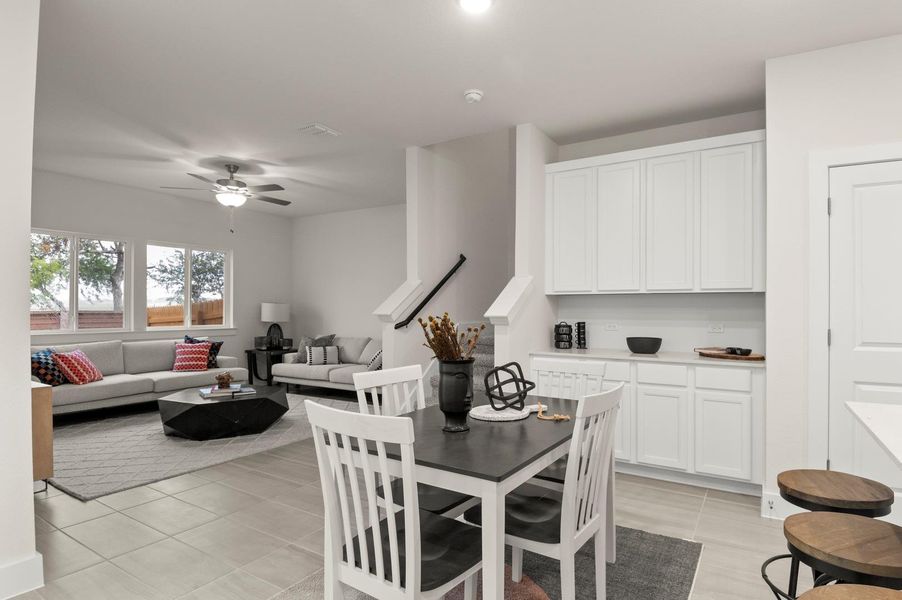 An open-concept layout unites living and dining areas, with large windows bringing in abundant natural illumination.