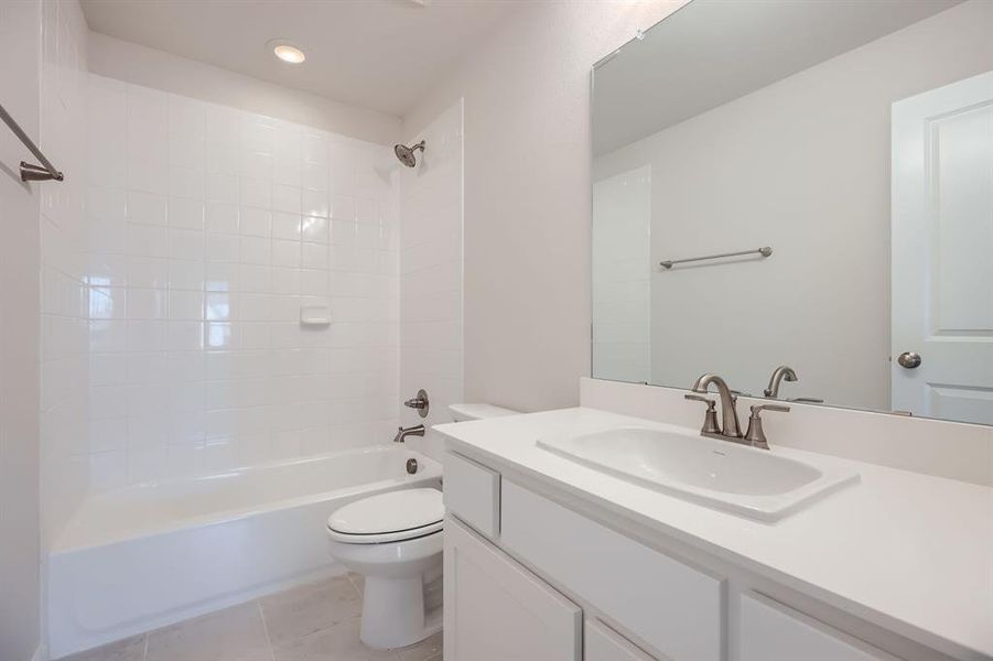 Full bath featuring vanity,  shower combination, tile patterned floors, and recessed lighting