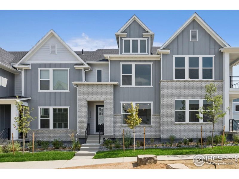 Front exterior of a new home in Kinston Mainstreet Townhomes, Loveland, CO, highlighting curb appeal (Image 1). Front exterior of a new home in Kinston Mainstreet Townhomes, Loveland, CO, highlighting curb appeal (Image 1).