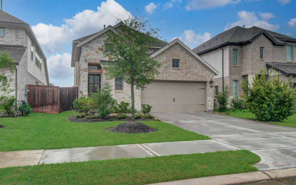 Front exterior of a new home in Candela, Richmond, TX, highlighting curb appeal (Image 22). Front exterior of a new home in Candela, Richmond, TX, highlighting curb appeal (Image 22).