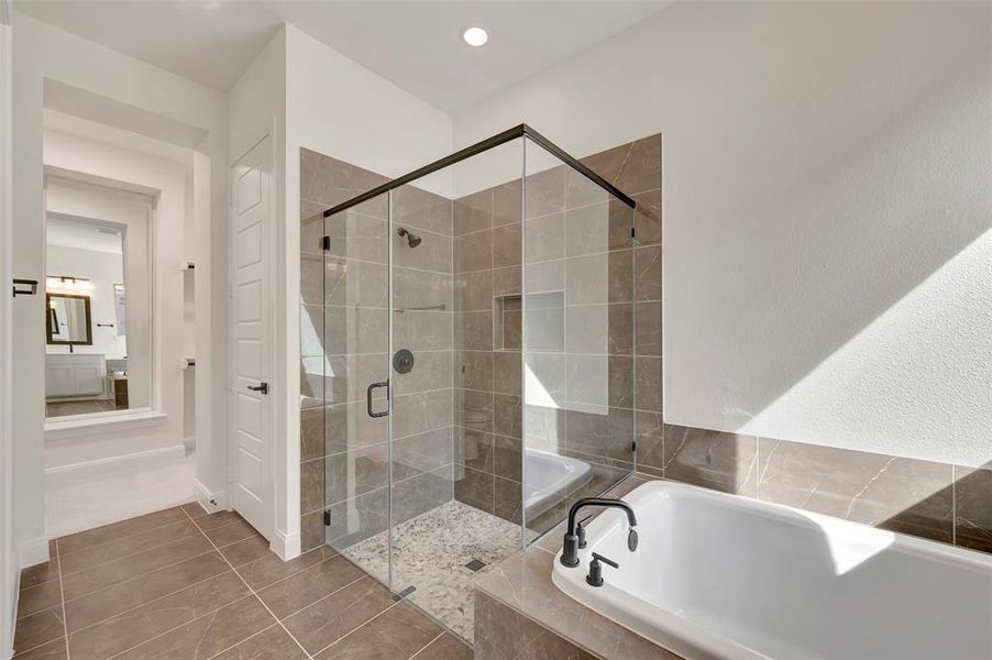 Bathroom with a garden tub, a shower stall, tile patterned floors, and recessed lighting