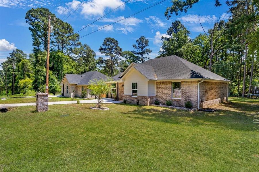 View of front of home featuring brick siding, a front lawn, and a shingled roof View of front of home featuring brick siding, a front lawn, and a shingled roof