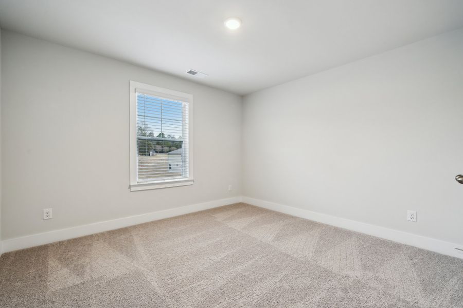 A room with a window and a carpet. A room with a window and a carpet.