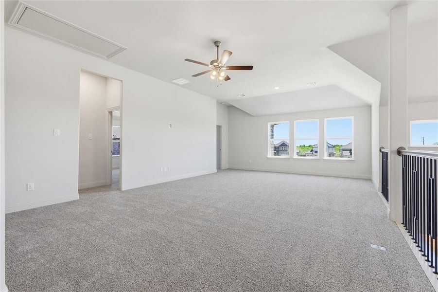 Unfurnished living room featuring light carpet and ceiling fan