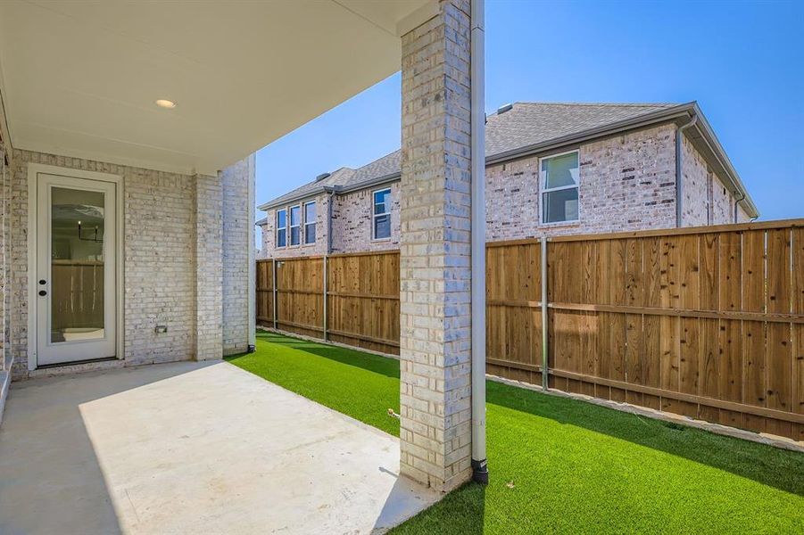 Fenced backyard with a patio area