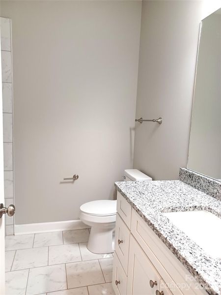 Hall Bath with linen storage behind door