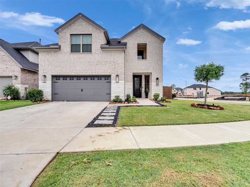 Front exterior of a new home in The Trails, New Caney, TX, highlighting curb appeal (Image 26).