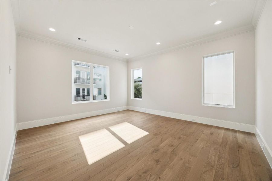 The Primary Suite is adorned with 10-foot ceilings and a designer light fixture. Exquisite Legno Bastone European White Oak wood floors continue in this space adding to its overall elegance and charm.