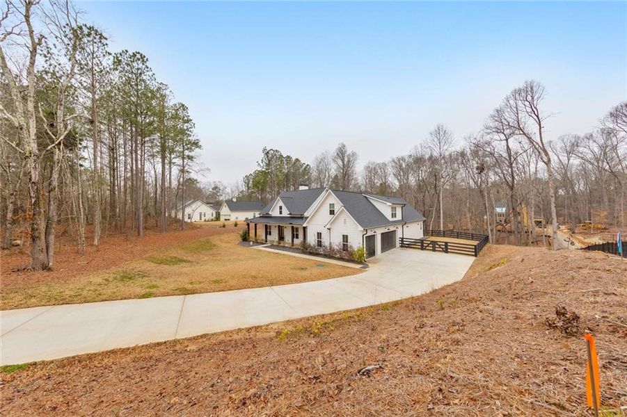 Front exterior of a new home in , Woodstock, GA, highlighting curb appeal (Image 29).
