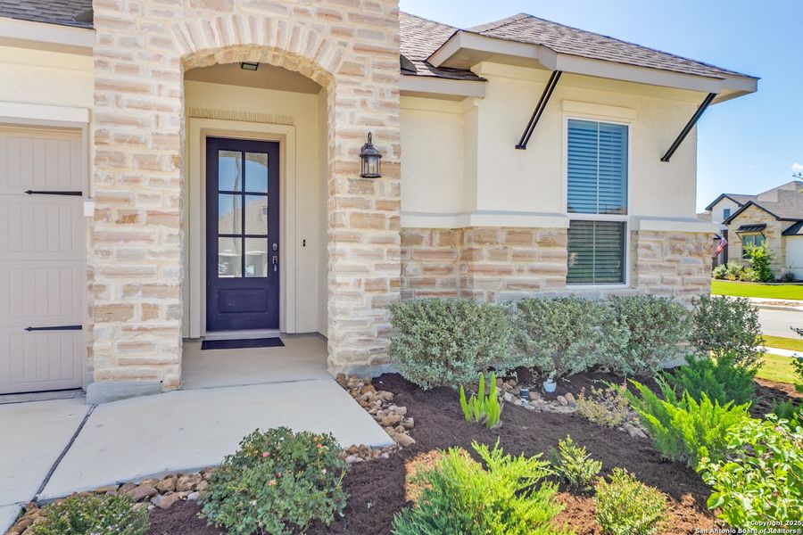 Front exterior of a new home in Esperanza 60', Boerne, TX, highlighting curb appeal (Image 17). Front exterior of a new home in Esperanza 60', Boerne, TX, highlighting curb appeal (Image 17).