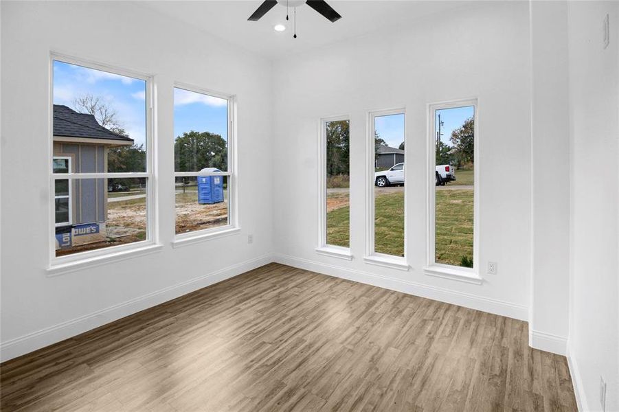Unfurnished room featuring light wood finished floors and a ceiling fan Unfurnished room featuring light wood finished floors and a ceiling fan