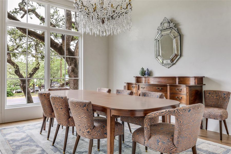 A refined dining space features large windows.