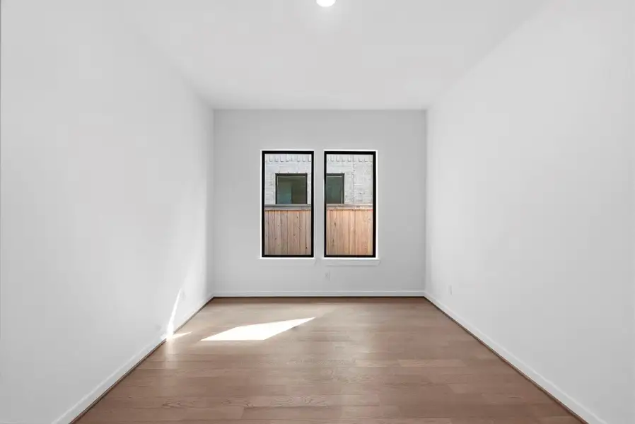 Oversized windows bring in ample amounts of light allowing this office to feel peaceful and airy.