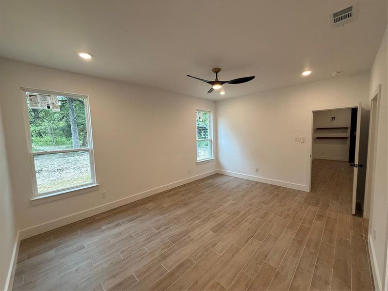 Unfurnished room featuring recessed lighting, light wood-style floors, and ceiling fan Unfurnished room featuring recessed lighting, light wood-style floors, and ceiling fan