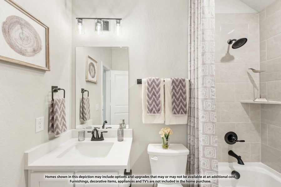 Bathroom with white vanity, large mirror, and tiled shower-tub combo with curtain Bathroom with white vanity, large mirror, and tiled shower-tub combo with curtain