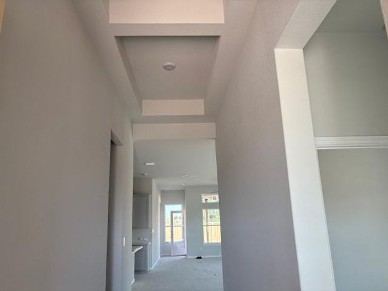 Hallway featuring a raised ceiling Hallway featuring a raised ceiling