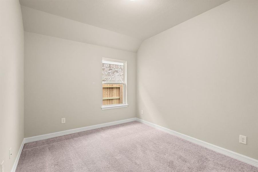 Your secondary bedroom features plush carpet, fresh paint, closet, and a large window that lets in plenty of natural lighting.