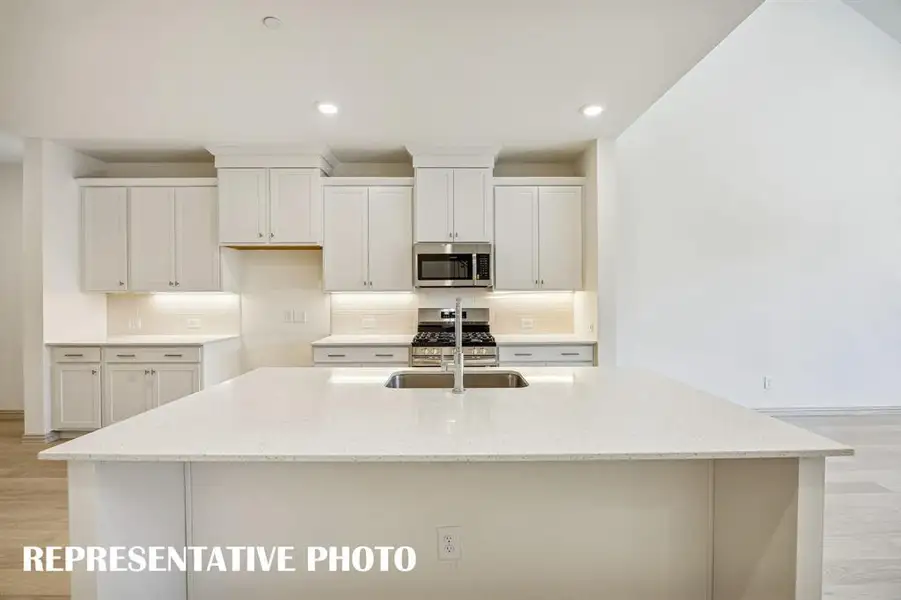 Your spacious kitchen island is the perfect place for friends and family to gather round!  REPRESENTATIVE PHOTO