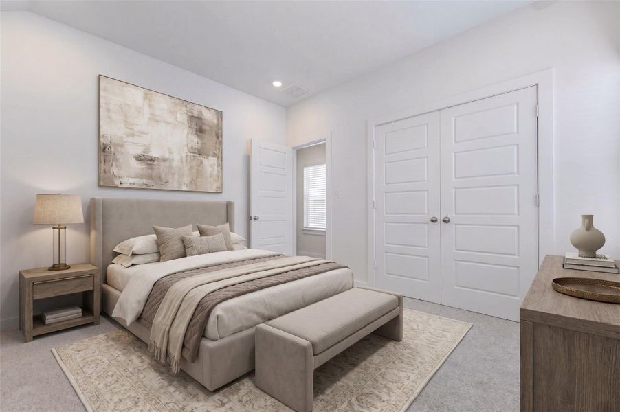 Secondary bedroom with soft carpet, neutral walls, recessed lighting, and double closet doors for generous storage. The simple, bright design makes this room flexible for a guest bedroom, child’s room, home office, hobby space, or quiet study area.