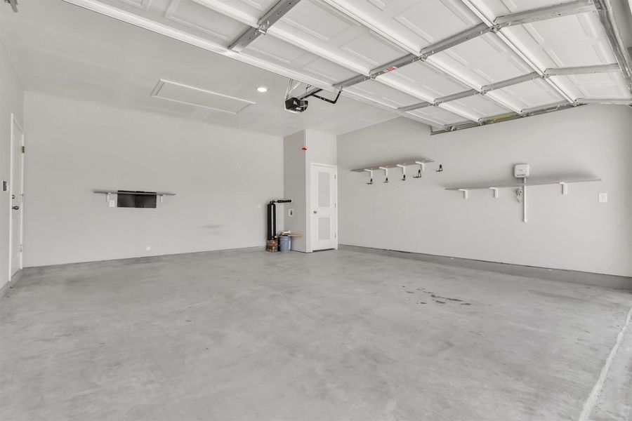 A spacious, newly finished garage offers ample storage and utility access.