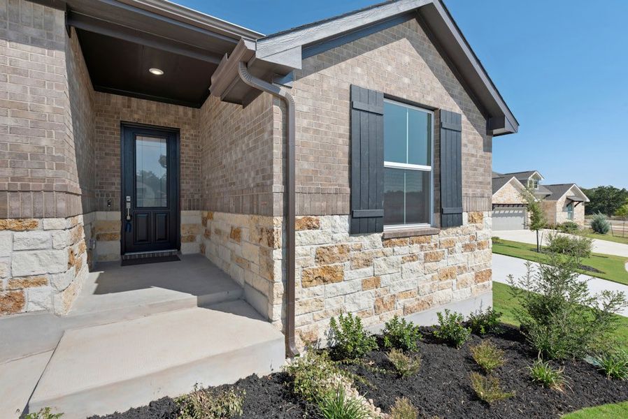 Exterior details and patio area of a home in The Colony, Bastrop (Image 3).