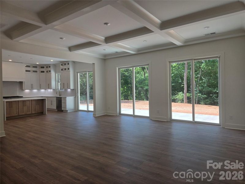 Great room open to the kitchen. Filled with light from the three 8ft doors overlooking the private backyard. Great room open to the kitchen. Filled with light from the three 8ft doors overlooking the private backyard.