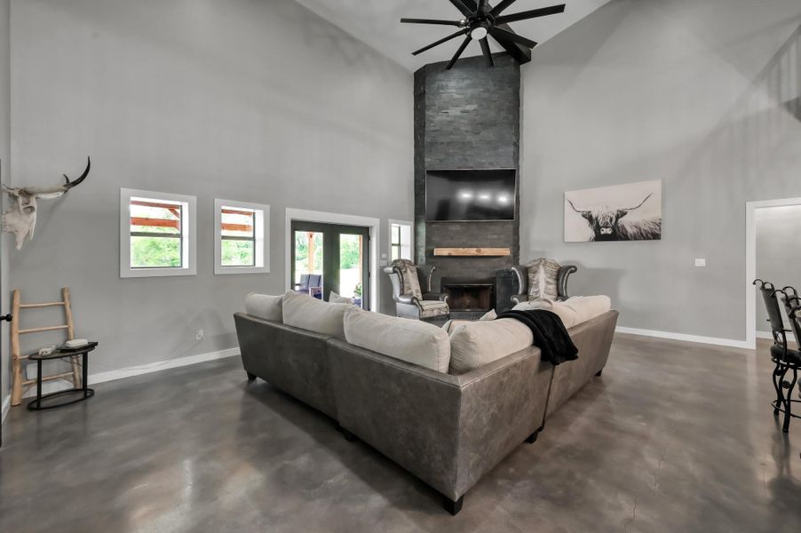 open-concept living area with polished concrete floors and high ceilings.