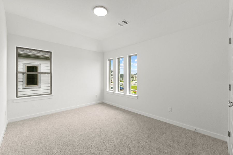 Bedroom in the Pearl home plan by Trophy Signature Homes – REPRESENTATIVE PHOTO