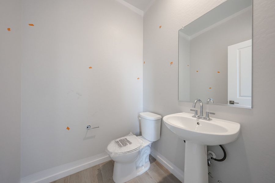 A bathroom with a toilet and sink. A bathroom with a toilet and sink.