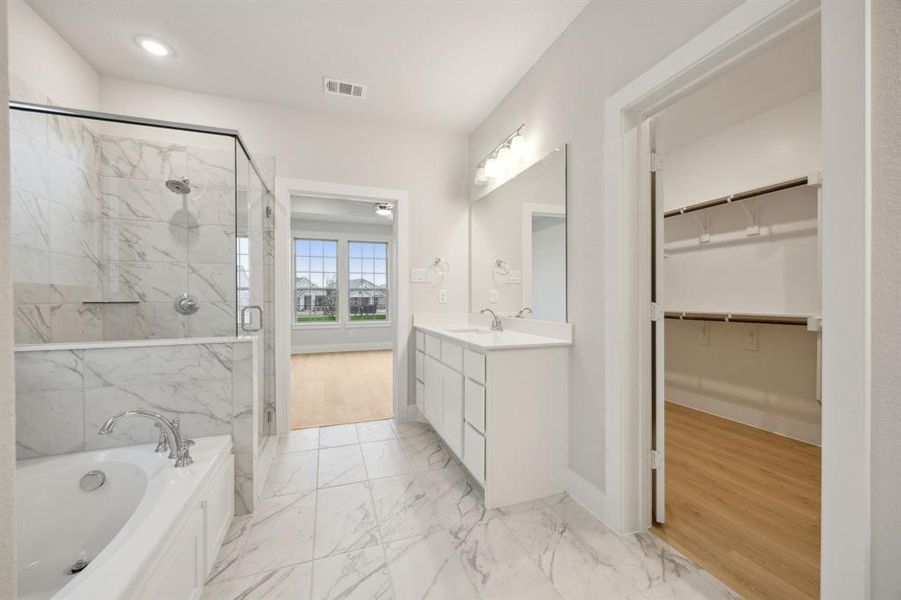 Bathroom featuring independent shower and bath and vanity