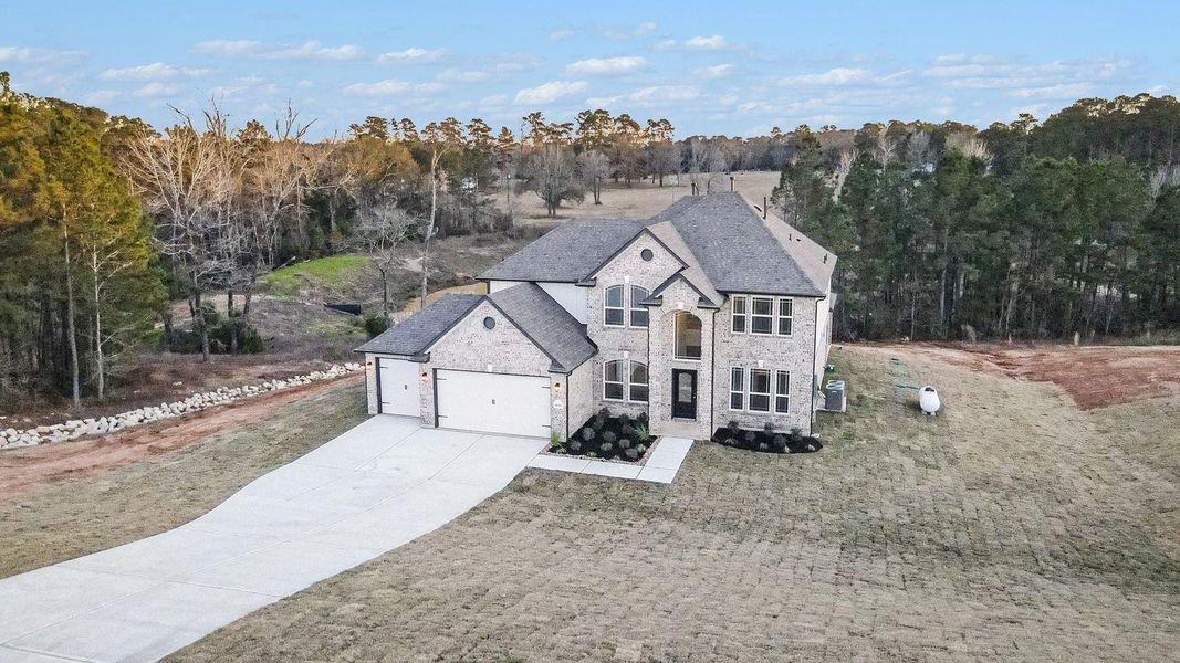 Front exterior of a new home in Rose Hill Estates, Willis, TX, highlighting curb appeal (Image 23).