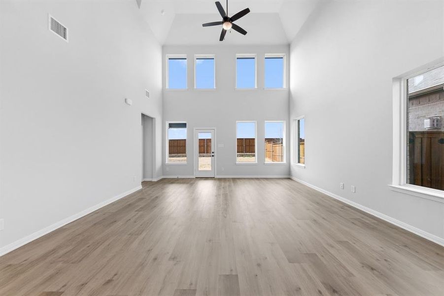 Featuring a dual stacked wall of windows, this wonderful family room is flooded with natural light.