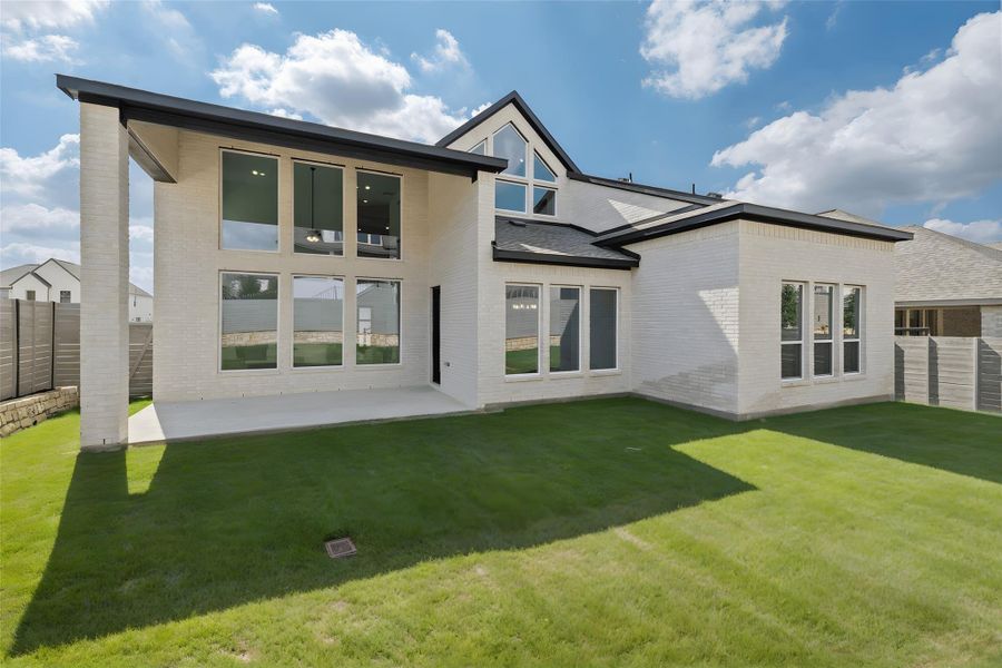 Rear view of house with brick siding, a fenced backyard, and a patio Rear view of house with brick siding, a fenced backyard, and a patio