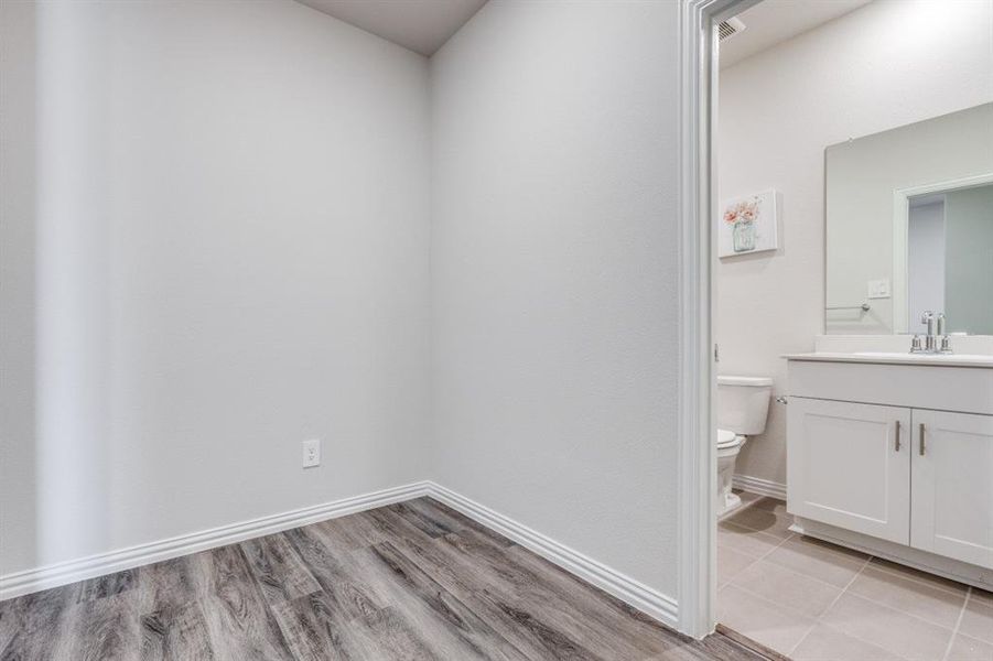 Bathroom featuring vanity and light wood finished floors