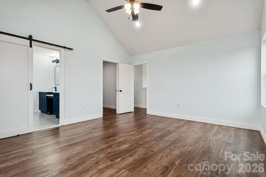 Primary bedroom on second level with cathedral ceiling, ceiling fan and recessed lighting