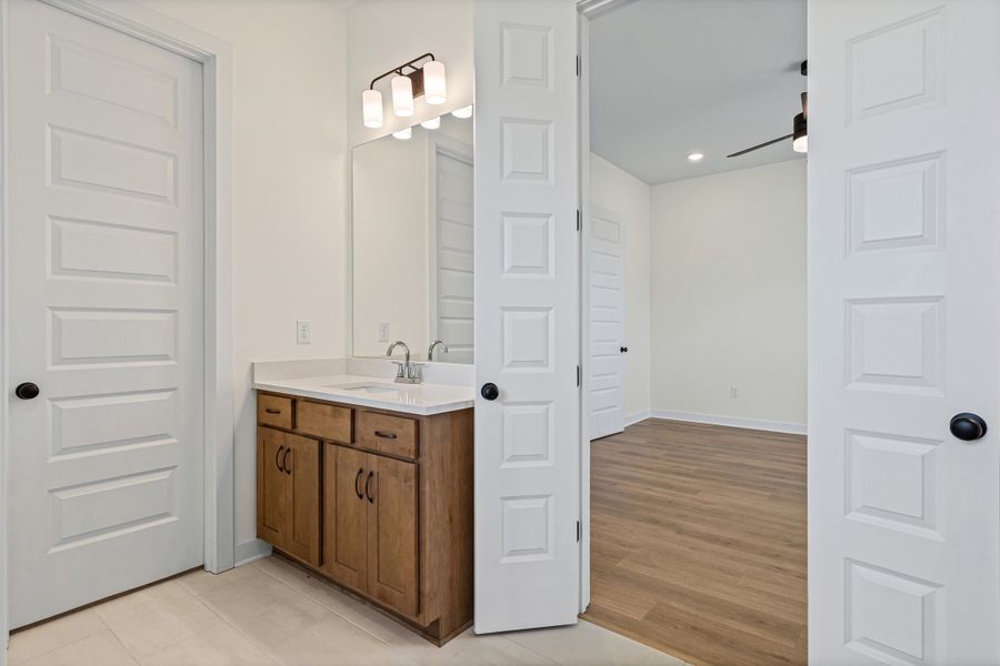 Bathroom vanity with a white countertop and rectangular sink Bathroom vanity with a white countertop and rectangular sink