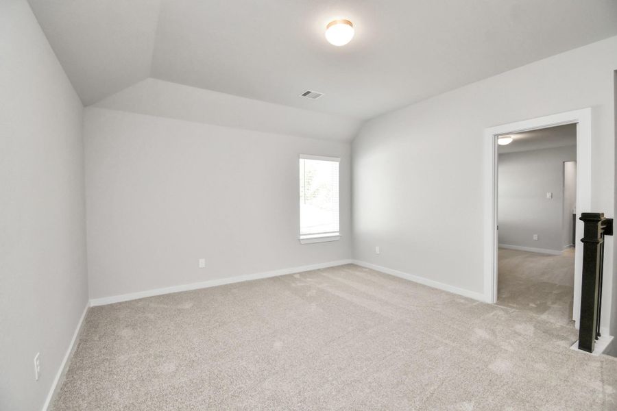 Ascend to relaxation in this fantastic game room! Ideal for both casual gatherings and adult gaming, it boasts plush carpet, lofty ceilings, custom paint, and ample windows for abundant natural light. Sample photo of completed home with similar floor plan. Actual colors and selections may vary.