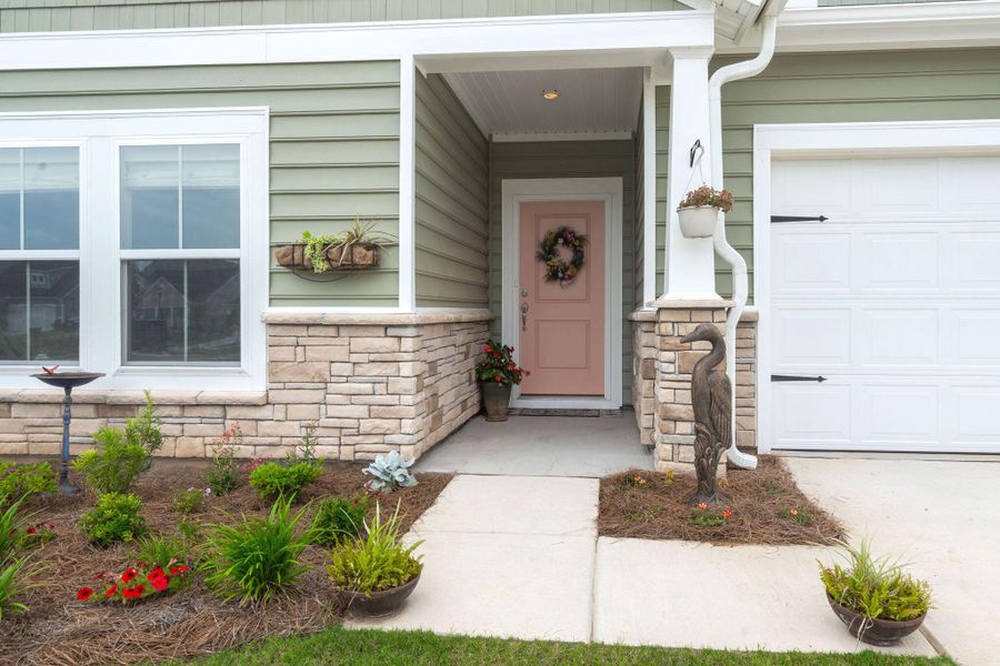Front exterior of a new home in Horizons at Summers Corner | 55+: The Legends, Summerville, SC, highlighting curb appeal (Image 28).