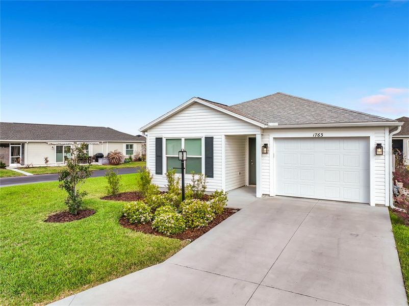 Front exterior of a new home in , The Villages, FL, highlighting curb appeal (Image 23).