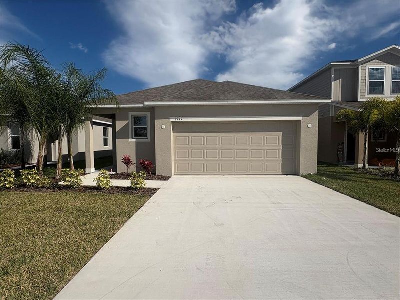 Front exterior of a new home in Villamar, Winter Haven, FL, highlighting curb appeal (Image 1). Front exterior of a new home in Villamar, Winter Haven, FL, highlighting curb appeal (Image 1).