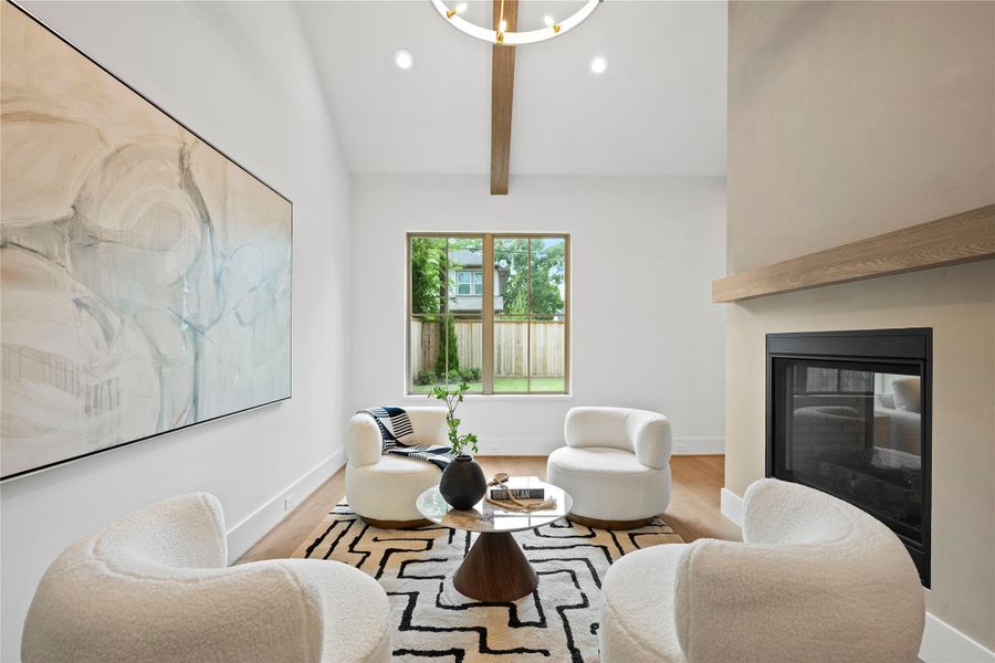 This intimate den-like nook, complete with a double-sided fireplace, offers a serene space for quiet reading, casual lounging, or cozy evenings. This intimate den-like nook, complete with a double-sided fireplace, offers a serene space for quiet reading, casual lounging, or cozy evenings.